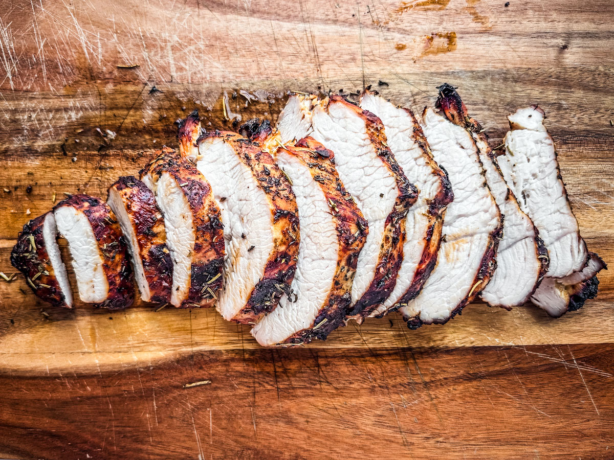 Juicy sliced turkey breast on a cutting board.