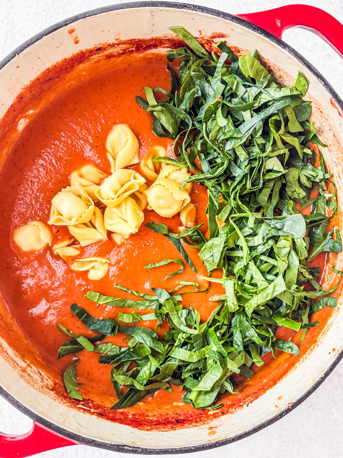 Smooth and creamy tomato soup with tortellini and spinach added in.