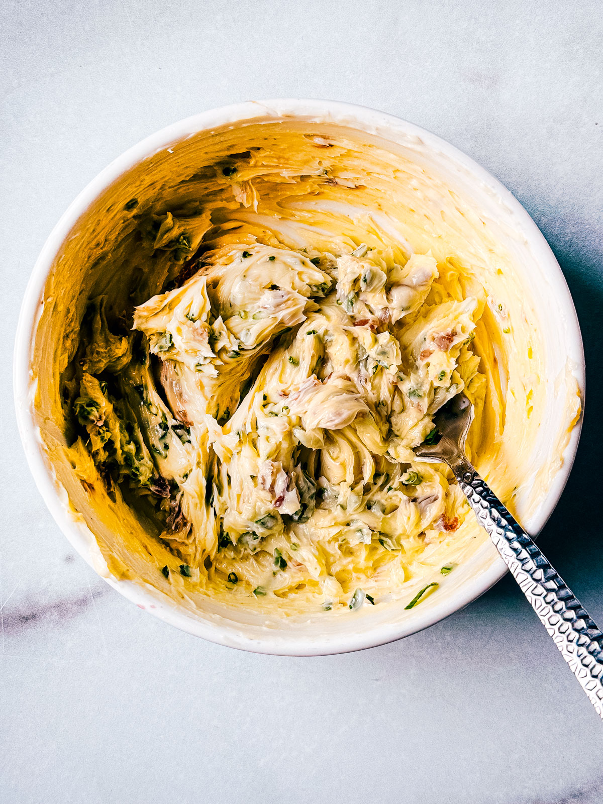 Bowl of anchovy butter with chives.