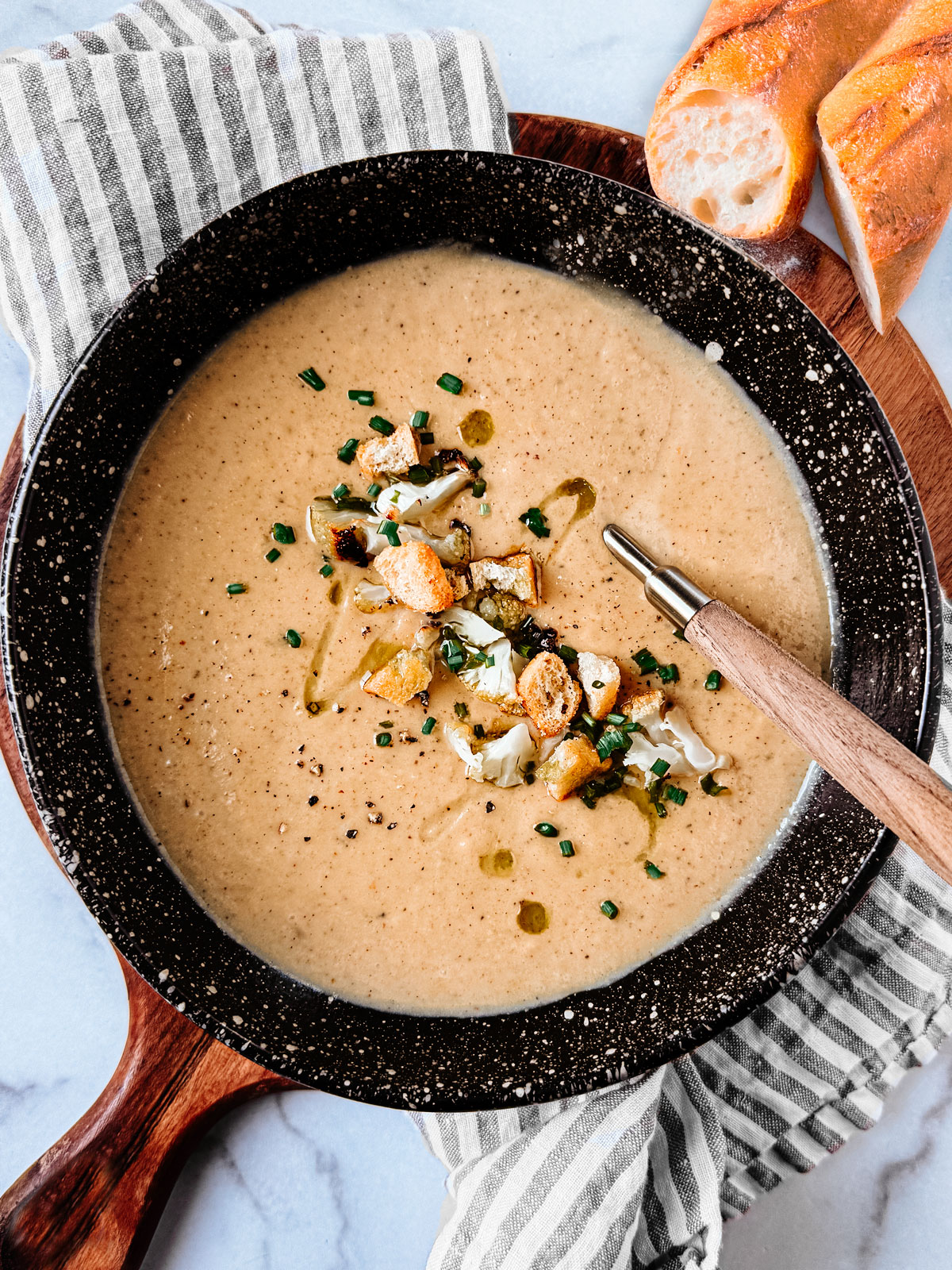 Bowl of roasted cauliflower soup with cheese.