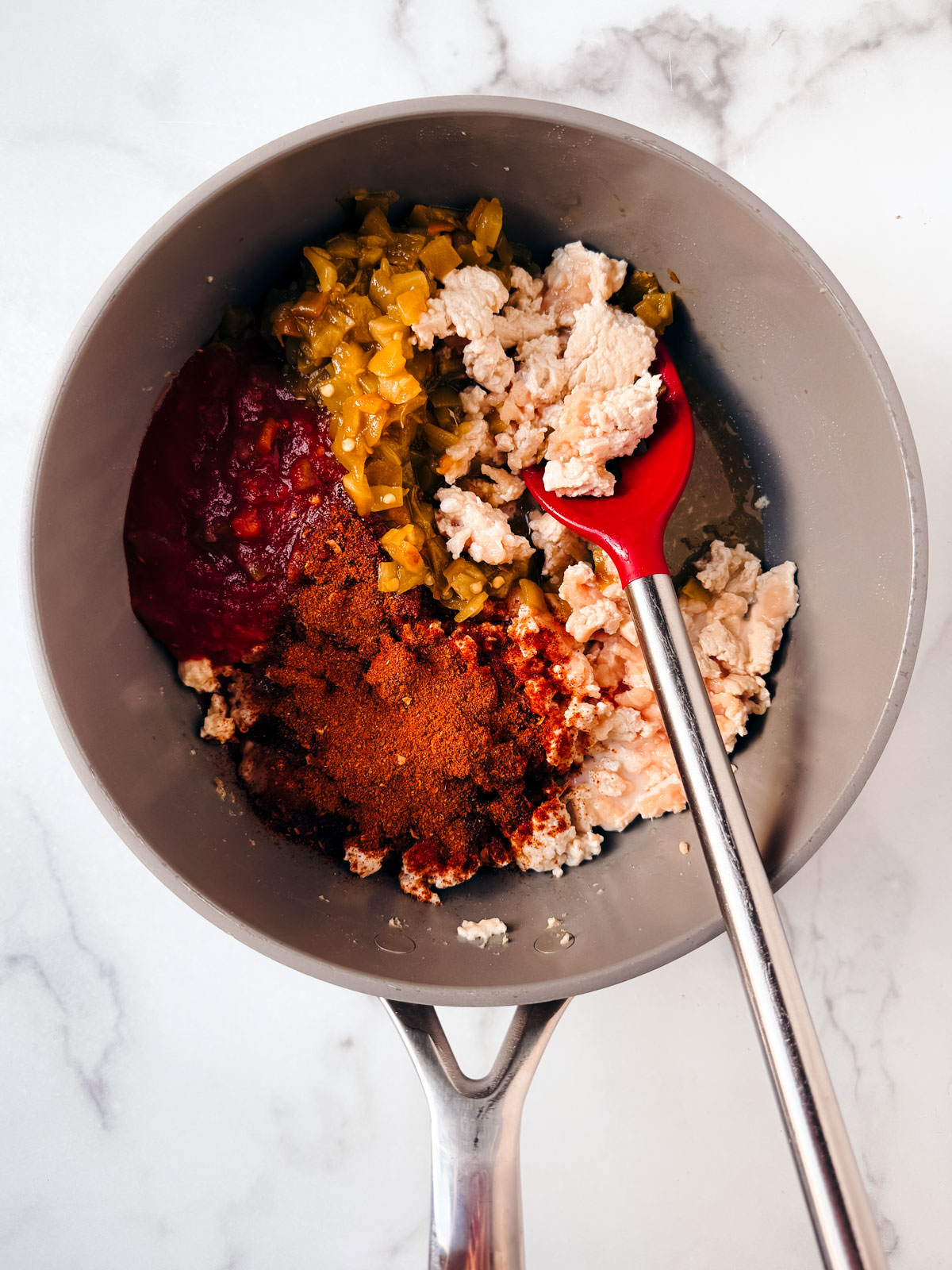 Ground chicken, spices, salsa, and chiles in a pan.