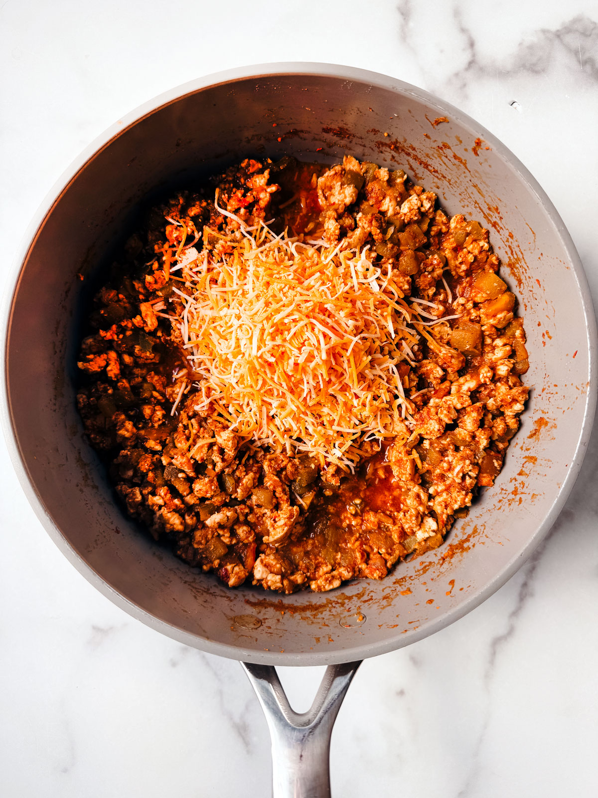 Cheese added to the pan of taco meat mixture.