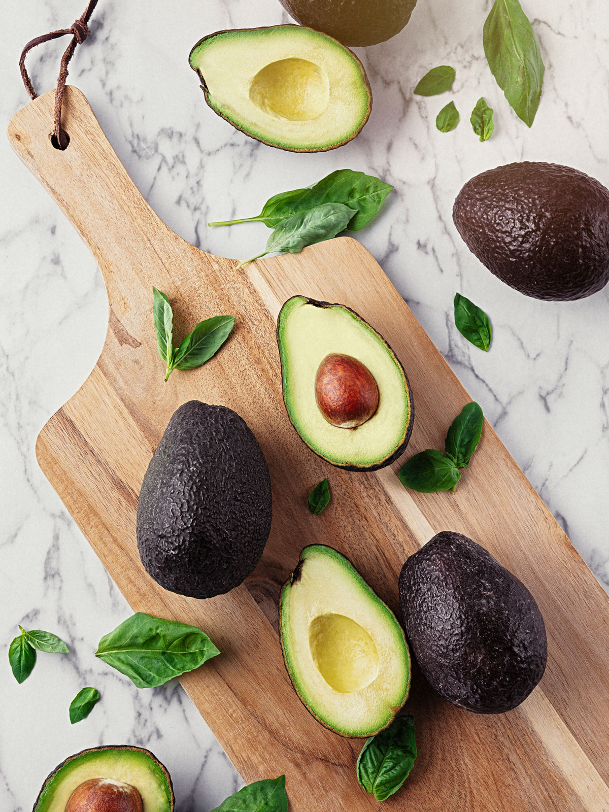 Avocados on a cutting board.