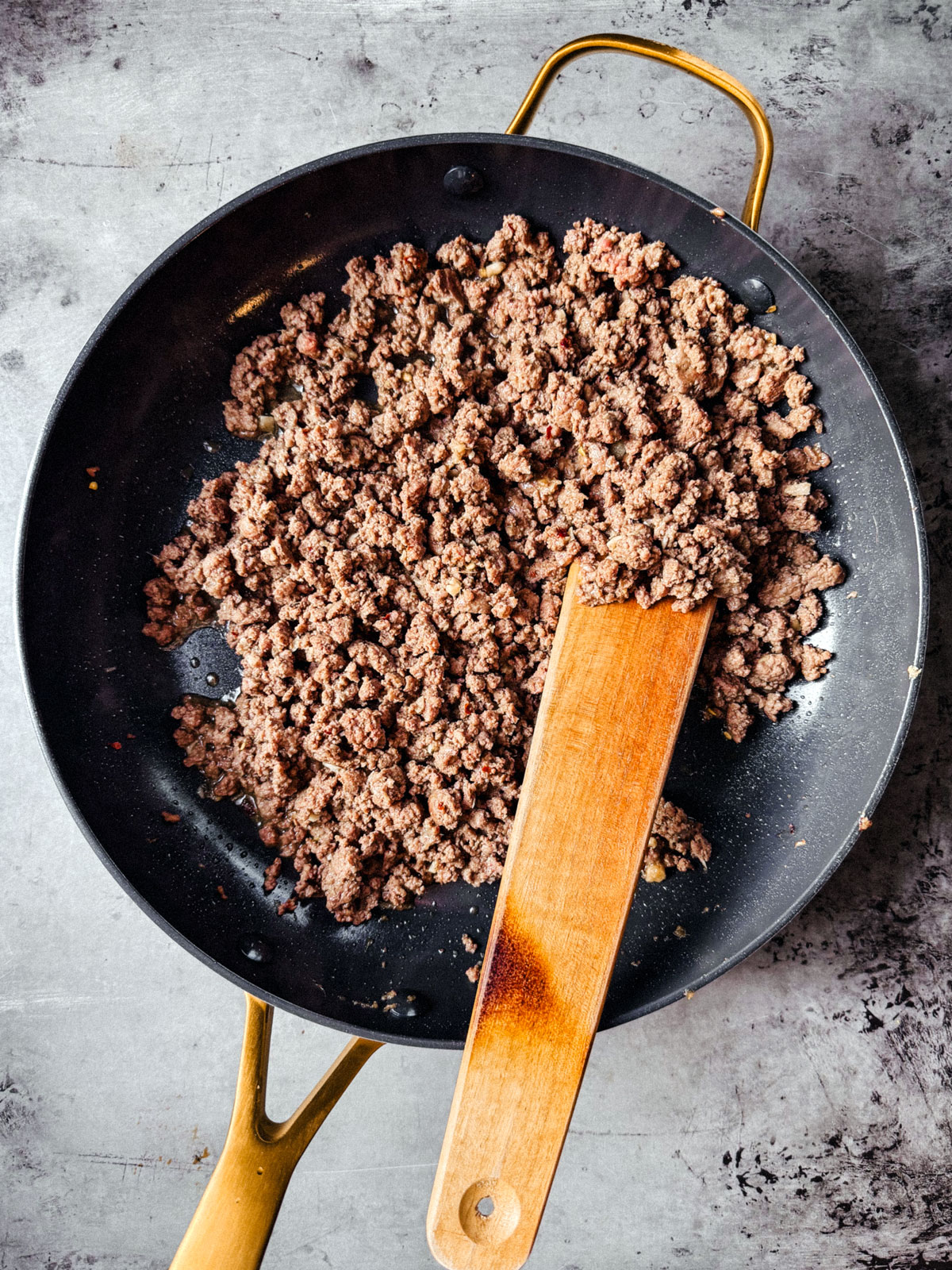 Pan with cooked ground beef. 