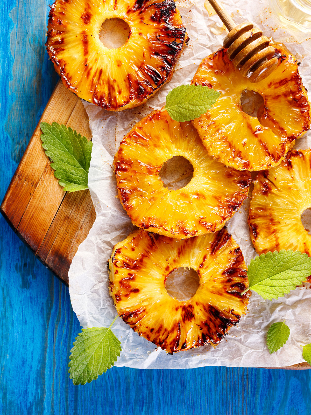 Grilled pineapple on a serving board.