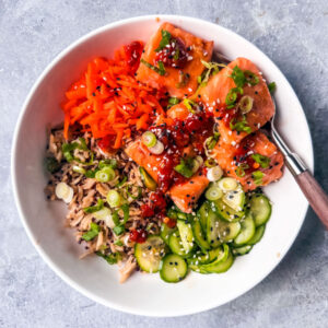 Rice bowl with salmon and cucumbers.