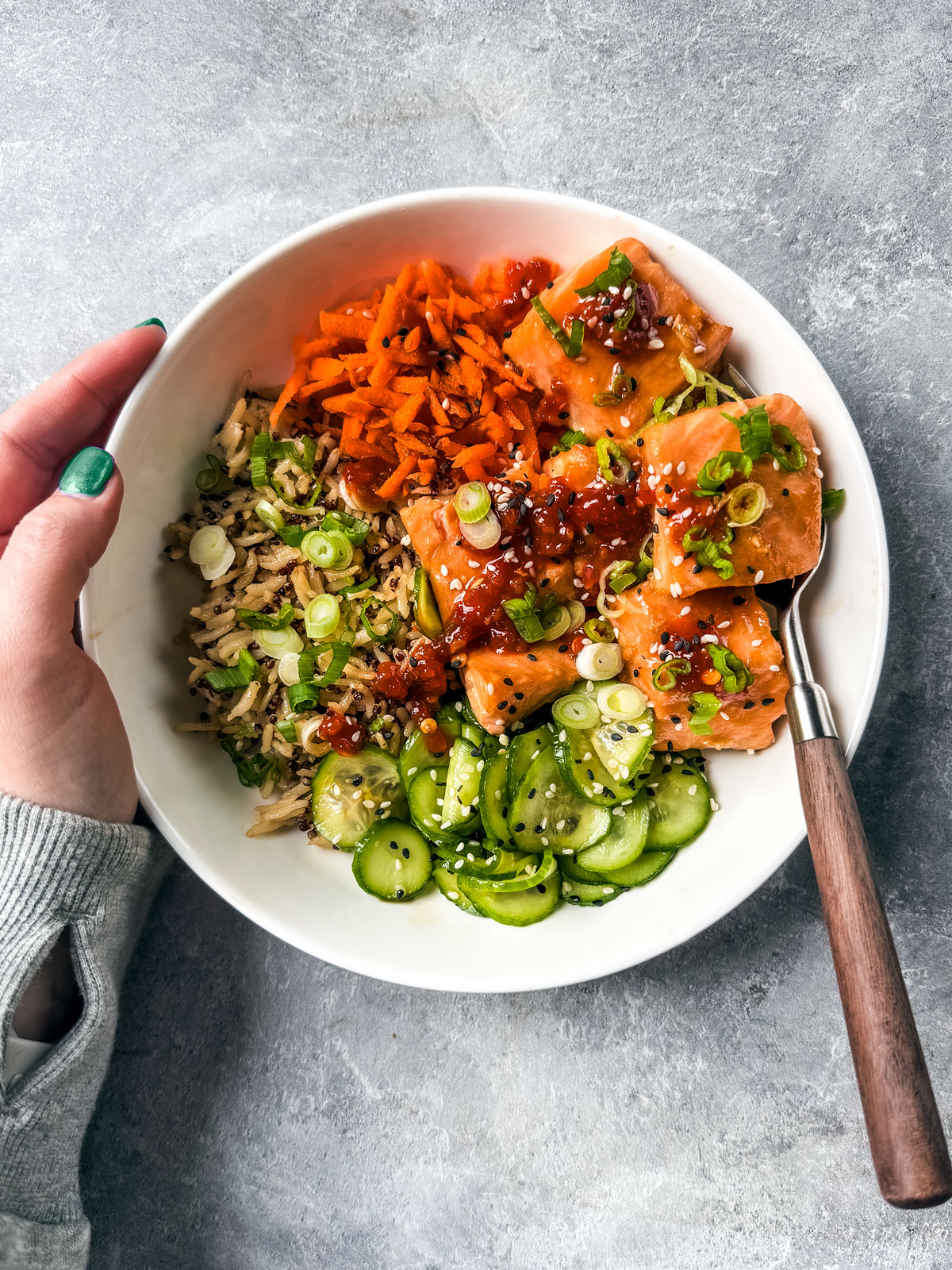 Rice bowl with salmon, cucumbers, and carrots.