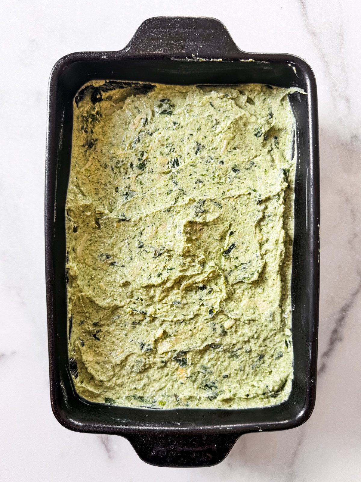 Dip mixture spread out in a baking dish.